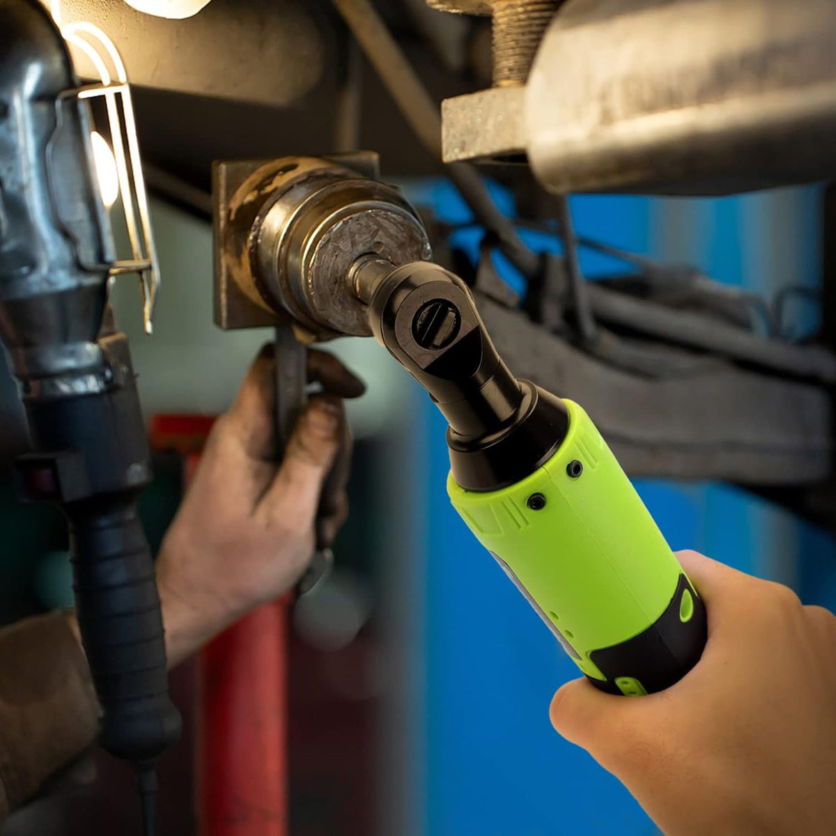 Cordless ratchet loosening a bolt on a vehicle